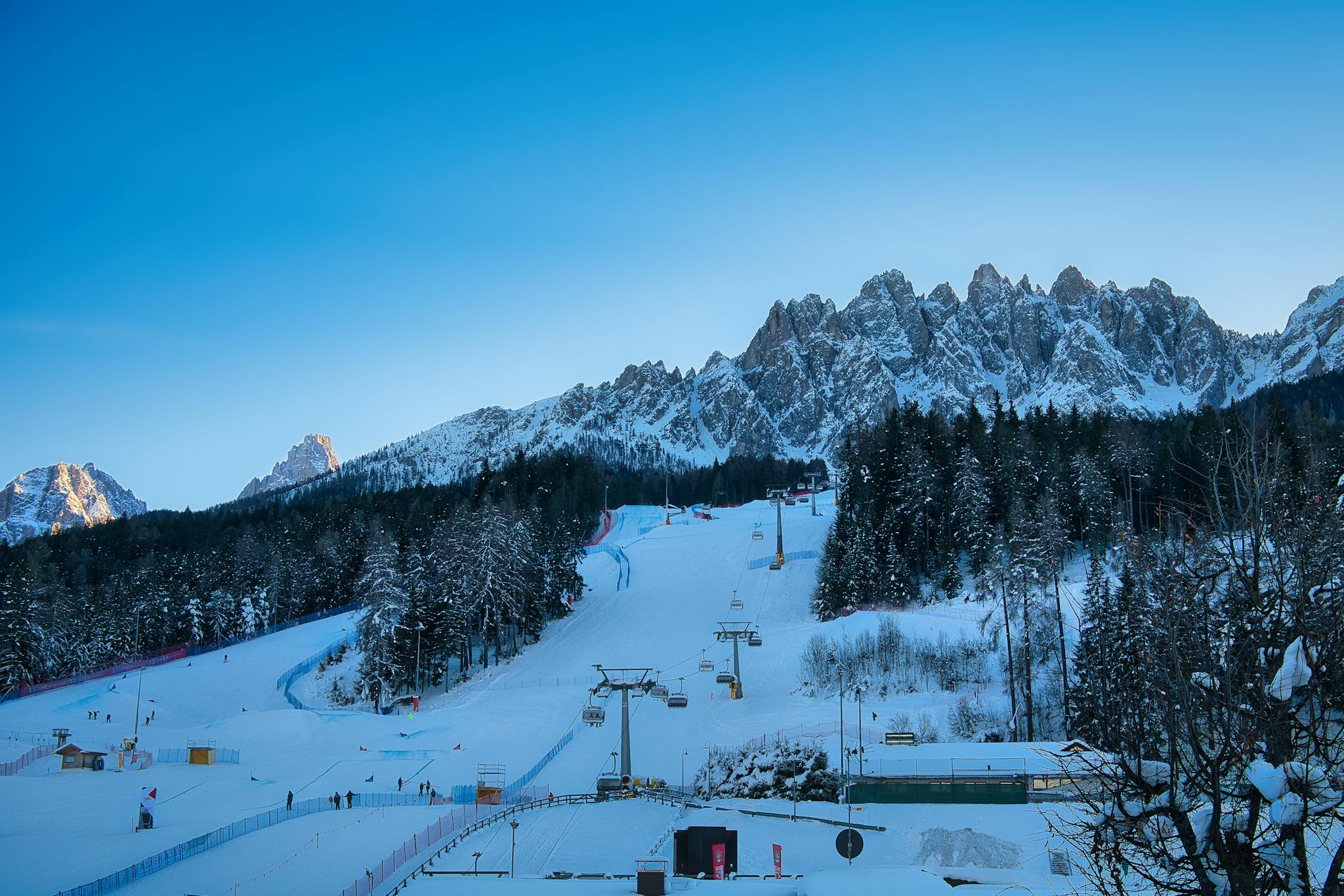 Capture the stunning winter landscape and ski lift at Innichen, Italy's Dolomites, perfect for winter sports enthusiasts.