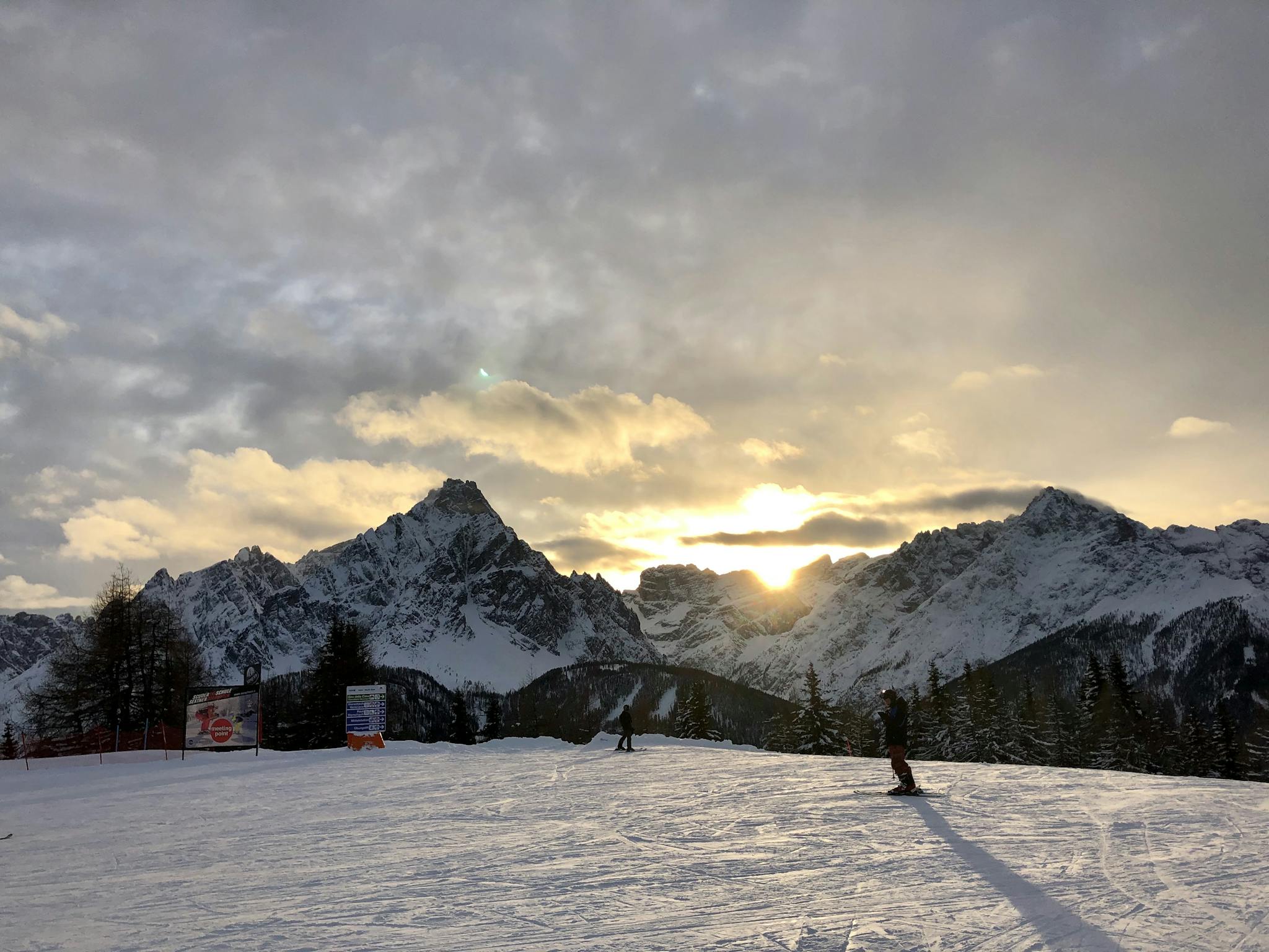 Skiers enjoy a sunset over the snowy Dolomites in Trentino-South Tyrol, Italy.